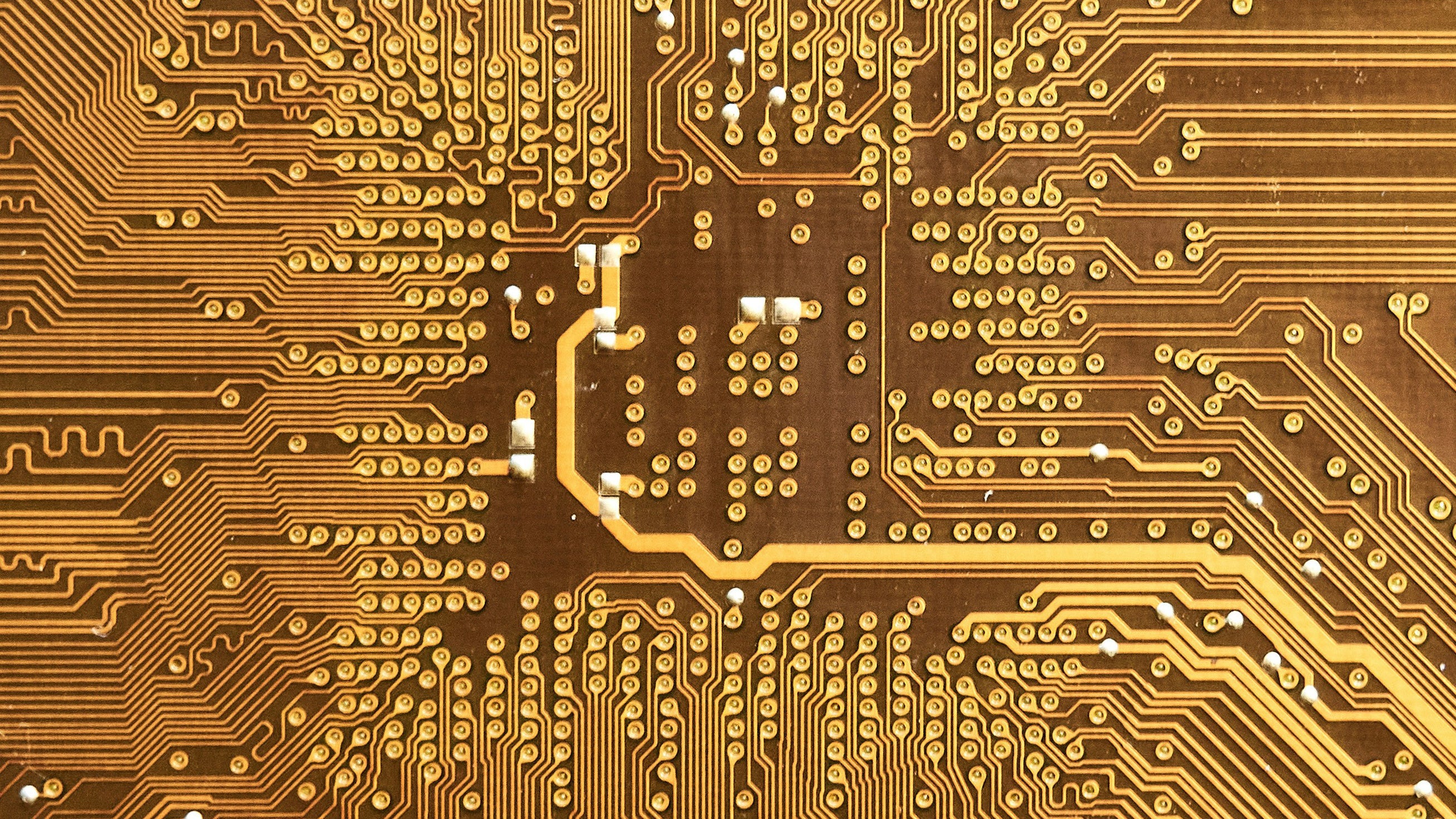 A bright gold circuit board up close.